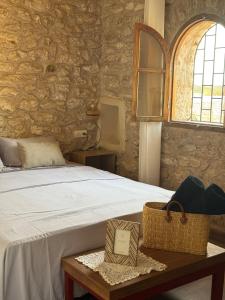 a bedroom with a bed with a table and a window at Holy house in Essaouira +12 photos