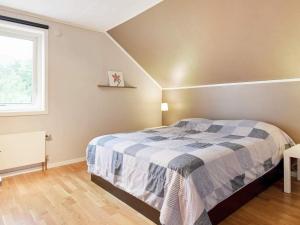 a bedroom with a bed with a blue and white blanket at 6 person holiday home in kode in Kode +5 photos