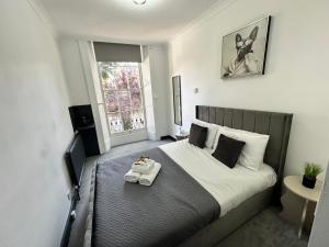 a bedroom with a large bed with a tray on it at Magic Stay Rooms in London +253 photos