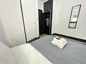 a bedroom with a bed with a towel on it at Magic Stay Rooms in London +235 photos