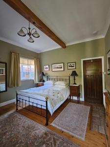a bedroom with a large bed and a window at The Old School B&B in Chichester