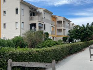 a building with a fence in front of it at Appartement 5 places 300m de la plage in Argelès-sur-Mer