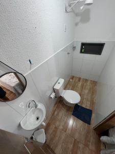 a bathroom with a toilet and a sink and a mirror at Pousada flor do sertão in Piranhas +62 photos