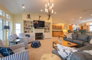 a living room with couches and a tv at Beach Cabana in Southern Shores