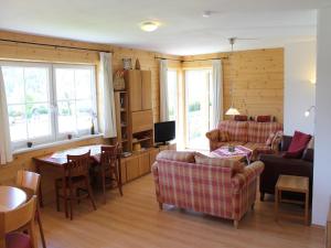 a living room with couches a table and a television at Apartment in St Michael near Ski Slopes in Sankt Martin