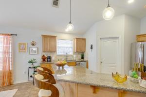 a kitchen with wooden cabinets and a counter top at 3 Mi to Escambia Bay Home with Deck and Private Yard! in Milton