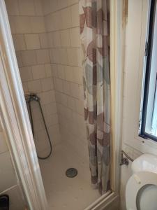 a bathroom with a shower with a shower curtain at Enjoy Pirineos in Huesca +6 photos