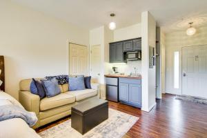 a living room with a couch and a kitchen at Renovated Resort Condo, 2 Mi to Silver Dollar City in Reeds Spring
