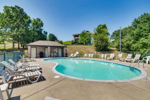 a swimming pool with chairs and a gazebo at Renovated Resort Condo, 2 Mi to Silver Dollar City in Reeds Spring