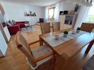a dining room and living room with a table and chairs at Im Idyll 3 in Hengersberg