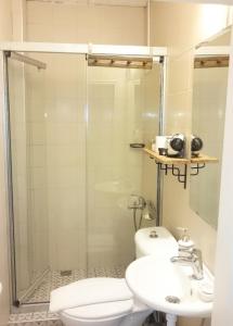 a bathroom with a shower and a toilet and a sink at Morlimon in Alaçatı +33 photos