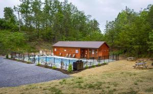 a log cabin with a pool in front of it at Peaceful Feeling by American Patriot Getaways in Seaton Spring