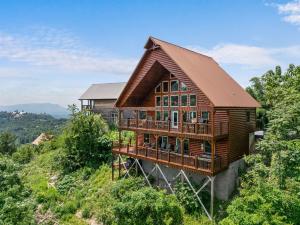 a wooden house on top of a hill at Peaceful Feeling by American Patriot Getaways in Seaton Spring
