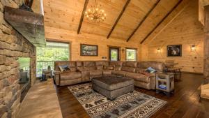 a living room with a couch and a table at Peak of Perfection by American Patriot Getaways in Rocky Grove