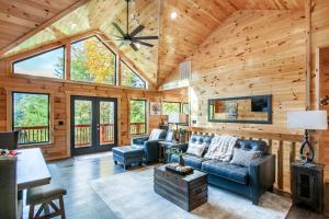 a living room with wooden walls and a ceiling with a clock at Relaxing With a View by American Patriot Getaways in Glade