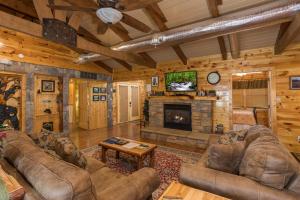 a living room with leather furniture and a fireplace at Rustic Ranch by American Patriot Getaways in Waldens Creek