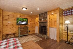 a living room with a fireplace and a tv at Rustic Ranch by American Patriot Getaways in Waldens Creek
