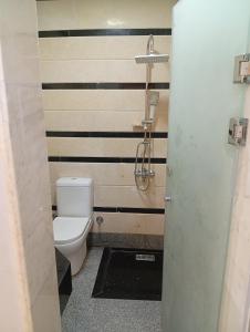 a bathroom with a toilet and a striped wall at ميراج باي اكوا بارك in Hurghada