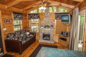 a living room with a couch and a fireplace at Seclusion by American Patriot Getaways in McCookville