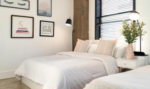 a bedroom with two beds and a window at Bright lights central Downtown in Los Angeles +15 photos