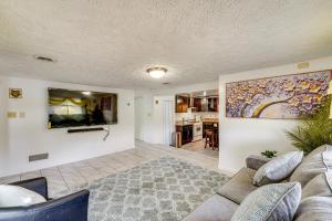 a living room with a couch and a painting on the wall at Cozy House on Meadowbrook Lake Serene, Scenic! in Stow