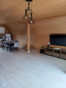 a large room with a flat screen tv and a table at COLȚ DE RAI - A Frame in Corbi