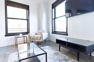 a living room with a table and a chair at Bright lights central Downtown in Los Angeles