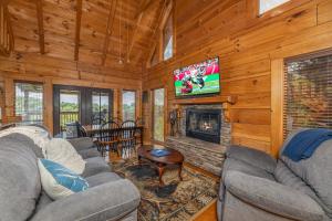a living room with couches and a fireplace and a tv at Smokies Serenity by American Patriot Getaways in Union Grove