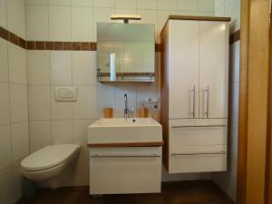 a white bathroom with a sink and a toilet at Ferienwohnung Regau 