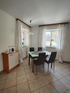 a kitchen and dining room with a table and chairs at Ferienwohnung Regau  +2 photos