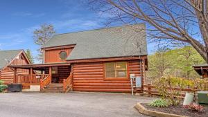 a log cabin with a porch and a driveway at Smoky Mountain Escape by American Patriot Getaways in Henderson Springs