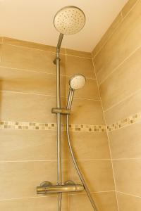 a shower with a shower head in a bathroom at Cocon neuf entre mer et campagne 4Pers Parking privé in Villers-sur-Mer +33 photos