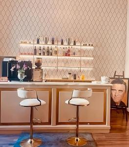 a kitchen with a counter with two bar stools at Fly in Viareggio beach in front of the famous promenade with shops and establishments in Viareggio