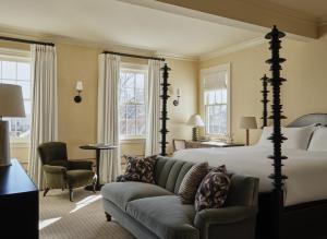 a hotel room with a bed and a couch at Belden House & Mews in Litchfield