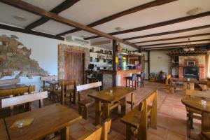 a restaurant with wooden tables and wooden chairs at B&B Tonivale - Heated Pool, Padel & Meeting Room in Skrbčići