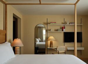 a hotel room with a bed and a mirror at Belden House & Mews in Litchfield +7 photos