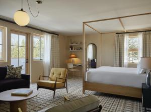 a bedroom with a large bed and a living room at Belden House & Mews in Litchfield