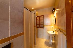 a small bathroom with a sink and a toilet at Casa Ceiba Huatulco - Adults Only in Santa Cruz Huatulco +40 photos