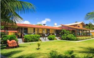 a house with a large yard in front of it at Pousada Canto do Porto in Porto De Galinhas +25 photos