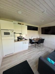 a kitchen and living room with a table and chairs at Cozy Guesthouse Liminka in Liminka