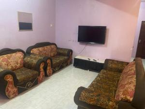 a living room with couches and a flat screen tv at Mastermind Semeling Homestay in Bedung