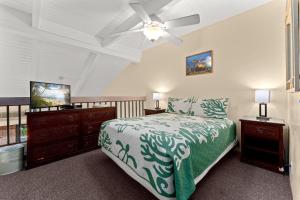 a bedroom with a bed and a ceiling fan at Maui Vista 2422 in Kihei +97 photos