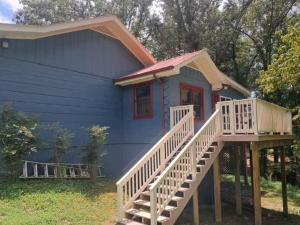 a blue house with a staircase leading up to it at Pigeon Ridge Cabin Cumberland State Park 2B 2B in Crossville