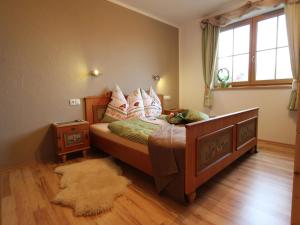 a bedroom with a bed with pillows and a rug at Holiday home in Taxenbach in Taxenbach