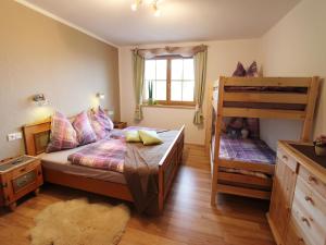a bedroom with a bed and a bunk bed at Holiday home in Taxenbach in Taxenbach