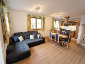 a living room with a couch and a table at Holiday home in Taxenbach in Taxenbach +18 photos