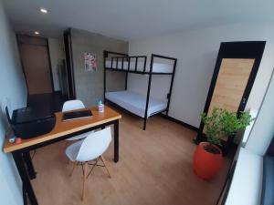 a room with a desk and a bunk bed at Habitaciones junto a Clinica Marly in Bogotá +2 photos
