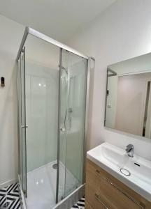a bathroom with a shower and a sink at Quiet apartment - Touraine in Sorigny