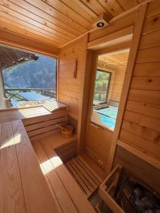 an inside view of a wooden cabin with a window at Mountain house Potkovica in Lazići