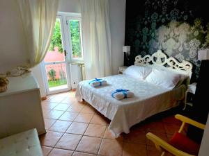 a bedroom with a bed with two towels on it at Il Bacio di Roma in Infernetto